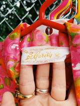 Women's vintage 1970's Bellariva label long sleeve ankle length button up shirt dress with collar. All over pink and orange floral print.