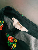 Women's vintage 1970's. Montgomery Ward label long sleeve black tunic blouse with a tie front neck and triangle shaped hem.