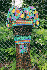 Women's vintage 1980's Carol Little label short sleeve midi length Summer dress with tropical floral print. Has a beaded wrap tie detail in the front.