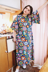 Women's vintage 1970's cotton material short sleeve maxi length dress with all over multicolored print. Has big flared sleeves and a V shaped neckline.