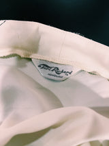 Women's vintage 1970's Tori Richard, Honolulu label cream colored long sleeve tunic blouse with floral print in the front and fabric buttons up the front.