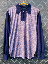 Women's or men's vintage 1970's long sleeve navy blue t-shirt with a paisley print on the front, a rounded dagger collar, and white popper buttons.