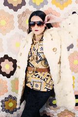 Women's vintage 1960's long sleeve genuine fur pea coat with a double breasted closure. Cream colored with all over brown speckles.