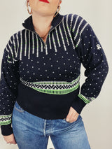 Women's vintage 1980's Demetre label long sleeve black pullover ski sweater with a half zip closure and white and green print all over.