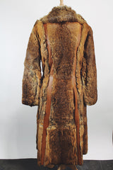 Women's vintage 1960's Apropos, Made in Korea label long sleeve knee length genuine fur coat with burnt orange leather trim and a tie belt.