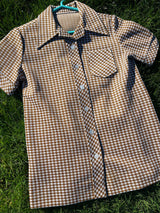 Women's vintage 1970's short sleeve button up shirt blouse in brown and white checkered print polyester material.