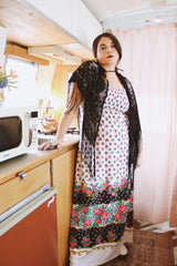 1970's vintage black lace triangle scarf with long fringe trim that can be worn as a shawl. Shop more vintage accessories at Live Forever Vintage.