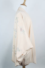 Women's vintage 1960's traditional kimono robe jacket in a pale pink color. Silk material with floral embroidery throughout.