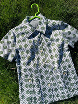 Women's vintage 1970's short sleeve button up shirt blouse in green and white print in polyester material.