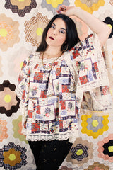 Women's vintage 1980's Lane Bryant label flutter sleeve blouse with cream lace trim and a square neckline. All over multicolored patchwork print.