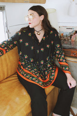 Women's vintage 1970's. Montgomery Ward label long sleeve black tunic blouse with a tie front neck and triangle shaped hem.