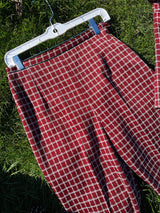 Women's vintage 1970's matching pant set with pants and a short sleeve button up shirt in maroon and white checkered print.
