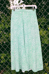 Women's vintage 1980's JH Collectibles, Made in USA label matching set in an all over green and white ditsy floral print. Short sleeve blazer jacket and midi skirt.