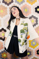 Women's vintage 1970's Tori Richard, Honolulu label cream colored long sleeve tunic blouse with floral print in the front and fabric buttons up the front.