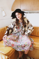 Women's vintage 1970's long sleeve multicolored patchwork genuine fur coat with hook and eye closures in the front. Grey, brown, cream, and black colors