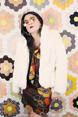 Women's vintage 1970's Wilsons Suede & Leather, Made in Korea label long sleeve bright white genuine fur coat with one hook and eye closure in the front.