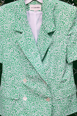 Women's vintage 1980's JH Collectibles, Made in USA label matching set in an all over green and white ditsy floral print. Short sleeve blazer jacket and midi skirt.