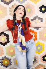 Women's vintage burnt orange acrylic crochet sweater top. Sleeveless with ruffles trim on shoulders. Has a short fit.