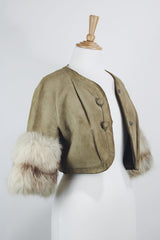 Women's vintage 1970's cropped fit tan suede jacket with short sleeves and two snap button closure in the front. Sleeves have a cream fur trim.