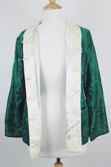 Women's vintage 1960's reversible long sleeve satin smoking jacket. Green on one side and cream on the other. Fabric buttons.