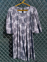 Women's vintage 1970's short length short sleeve grey printed dress with big bell sleeves in a cotton material.