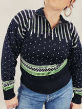 Women's vintage 1980's Demetre label long sleeve black pullover ski sweater with a half zip closure and white and green print all over.