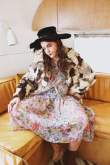 Women's vintage 1970's long sleeve multicolored patchwork genuine fur coat with hook and eye closures in the front. Grey, brown, cream, and black colors