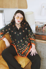 Women's vintage 1970's. Montgomery Ward label long sleeve black tunic blouse with a tie front neck and triangle shaped hem.