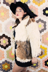 Women's vintage 1970's long sleeve genuine fur coat with double lapel in white with black and white patchwork details.