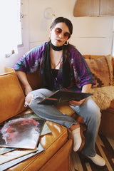 Women's vintage 1970's Cole of California label tie front blouse with balloon sleeves in purple, green, and orange colors and a lightweight polyester material.