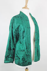 Women's vintage 1960's reversible long sleeve satin smoking jacket. Green on one side and cream on the other. Fabric buttons.