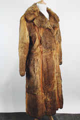 Women's vintage 1960's Apropos, Made in Korea label long sleeve knee length genuine fur coat with burnt orange leather trim and a tie belt.