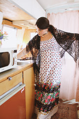 1970's vintage black lace triangle scarf with long fringe trim that can be worn as a shawl. Shop more vintage accessories at Live Forever Vintage.