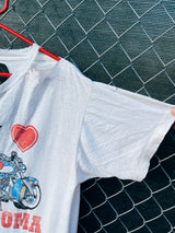 Women's or men's vintage 1980's Star California, Made in Chile label XL short sleeve white graphic t-shirt with Betty Boop on a motorcycle on the front.