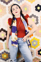 Women's vintage burnt orange acrylic crochet sweater top. Sleeveless with ruffles trim on shoulders. Has a short fit.