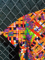 Women's vintage 1970's short sleeve mini length multicolored shift dress in polyester with v shaped neckline.