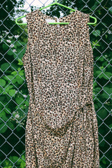 Women's vintage 1990's Maggy London label sleeveless midi length dress in an all over brown leopard print in a silk material. Wrap tie front detail.