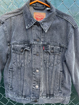 Women's Levi's black grey wash long sleeve button up lightweight jacket with brass hardware and pockets.