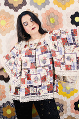 Women's vintage 1980's Lane Bryant label flutter sleeve blouse with cream lace trim and a square neckline. All over multicolored patchwork print.