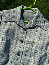 Women's vintage 1970's long sleeve button up shirt blouse in green and white printed polyester material.