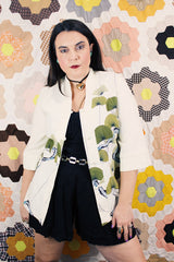 Women's vintage 1970's Tori Richard, Honolulu label cream colored long sleeve tunic blouse with floral print in the front and fabric buttons up the front.