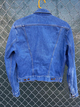 Women's vintage 1970's Wrangler, Made in USA long sleeve button up medium wash denim jacket with brass hardware and pockets.