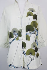 Women's vintage 1970's Tori Richard, Honolulu label cream colored long sleeve tunic blouse with floral print in the front and fabric buttons up the front.