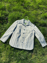 Women's vintage 1970's long sleeve button up shirt blouse in green and white printed polyester material.