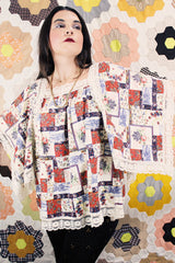 Women's vintage 1980's Lane Bryant label flutter sleeve blouse with cream lace trim and a square neckline. All over multicolored patchwork print.