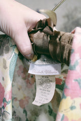 Women's vintage 1980's Elizabeth Williams, Made in USA label long sleeve floral print blazer with one button closure. All over pink, yellow, and tan flowers.