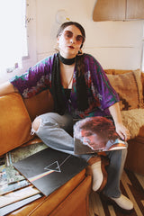 Women's vintage 1970's Cole of California label tie front blouse with balloon sleeves in purple, green, and orange colors and a lightweight polyester material.