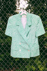 Women's vintage 1980's JH Collectibles, Made in USA label matching set in an all over green and white ditsy floral print. Short sleeve blazer jacket and midi skirt.