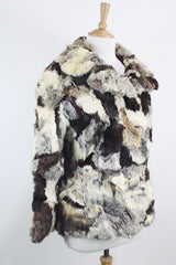 Women's vintage 1970's long sleeve multicolored patchwork genuine fur coat with hook and eye closures in the front. Grey, brown, cream, and black colors