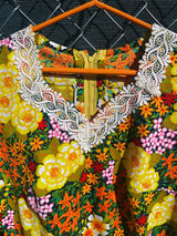 Women's vintage 1970's short sleeve mini length multicolored floral printed dress in polyester with lace trim collar.